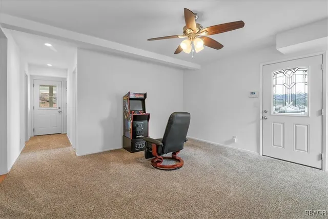 a view of a workspace with furniture and a window