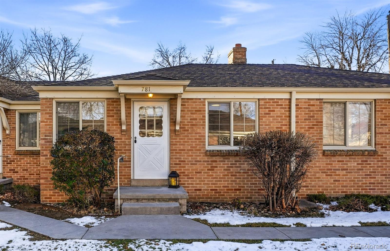 781 Forest Street Denver, CO 80220 - Photo 11 of 19 a front view of a house with garden