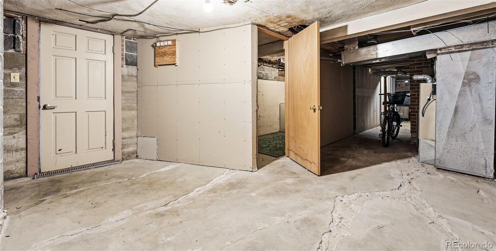781 Forest Street Denver, CO 80220 - Photo 18 of 19 a view of a hallway with a glass door and a refrigerator
