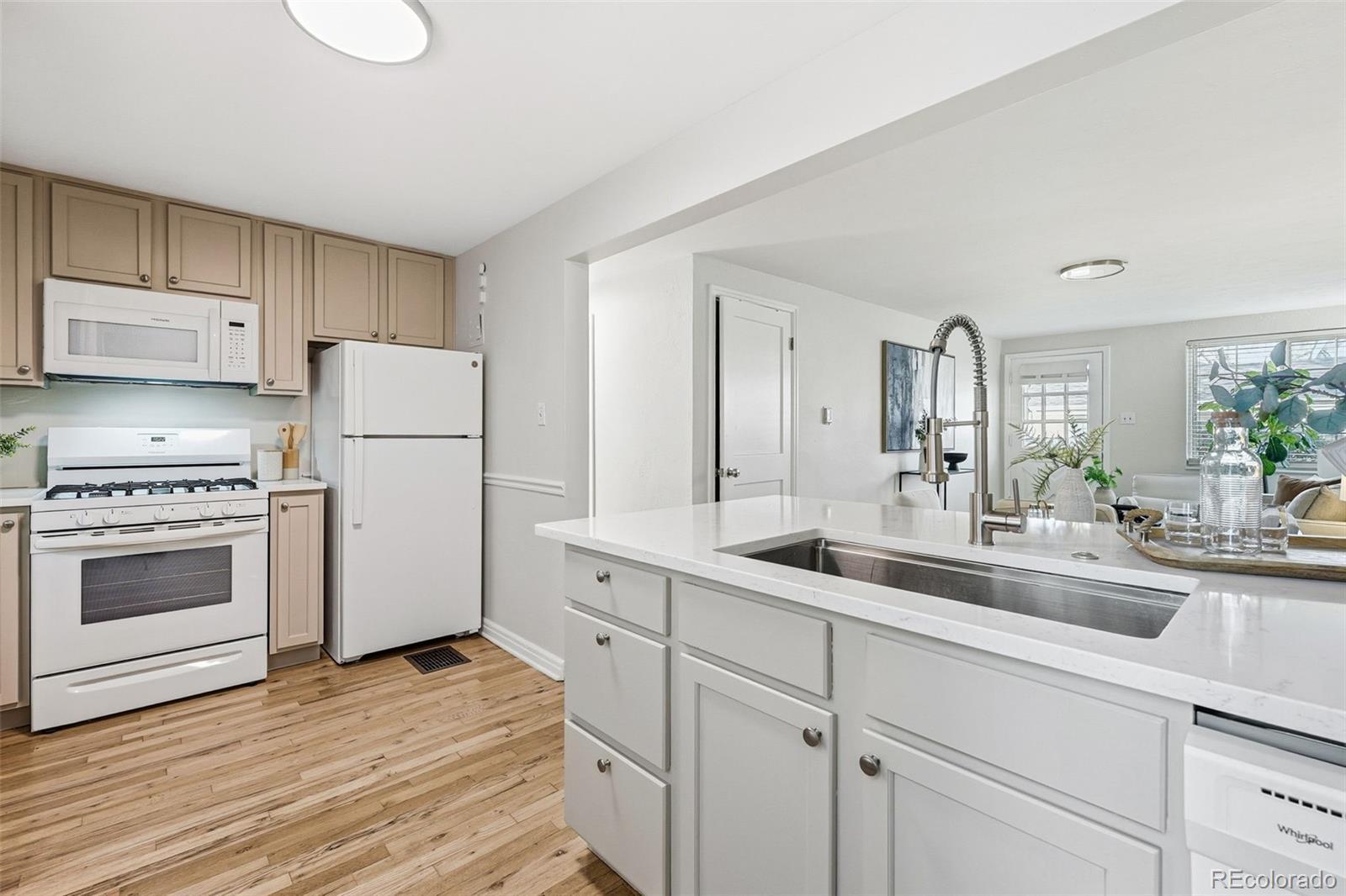 781 Forest Street Denver, CO 80220 - Photo 7 of 19 a kitchen with appliances a sink and cabinets