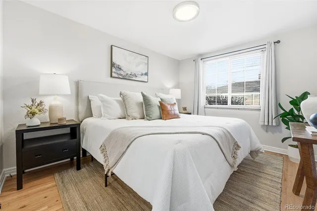 a bedroom with bed and a potted plant