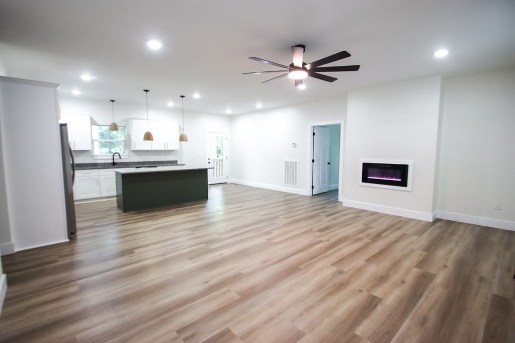 329 Webb Drive Sparta, TN 38583 - Photo 5 of 17 a view of a kitchen with wooden floor and a ceiling fan