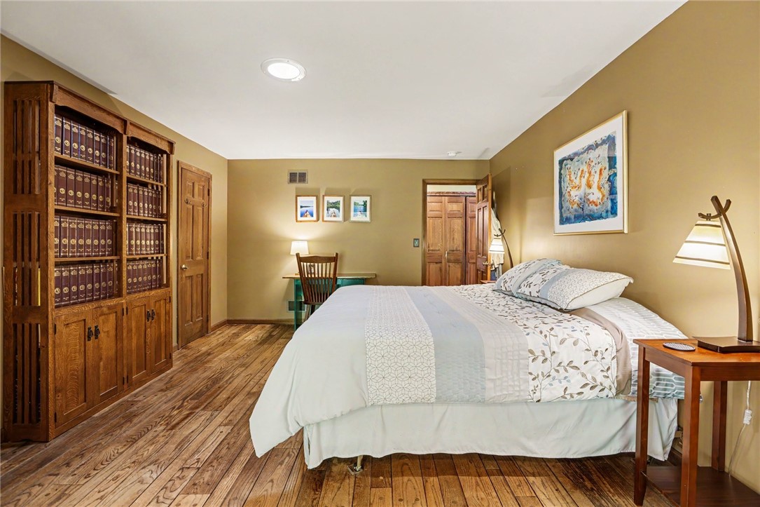 1722 Strong Road Victor, NY 14564 - Photo 11 of 33 Primary en-suite with hardwood floors, walk-in clo
