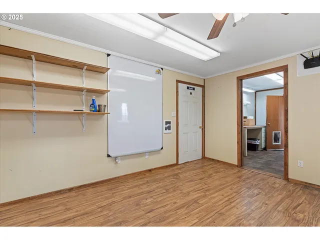 a view of empty room with wooden floor