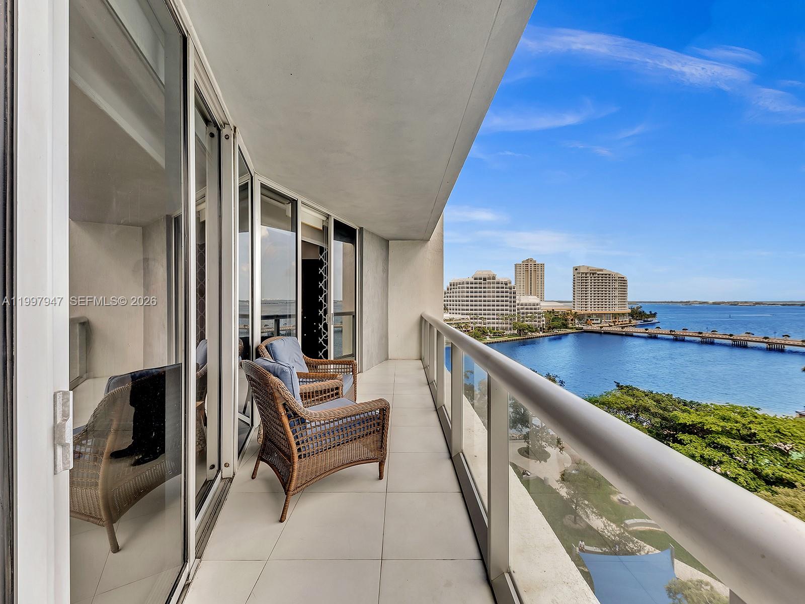 495 Brickell Avenue, Unit 1007 Miami, FL 33131 - Photo 1 of 17 a view of roof deck with two chairs and a table