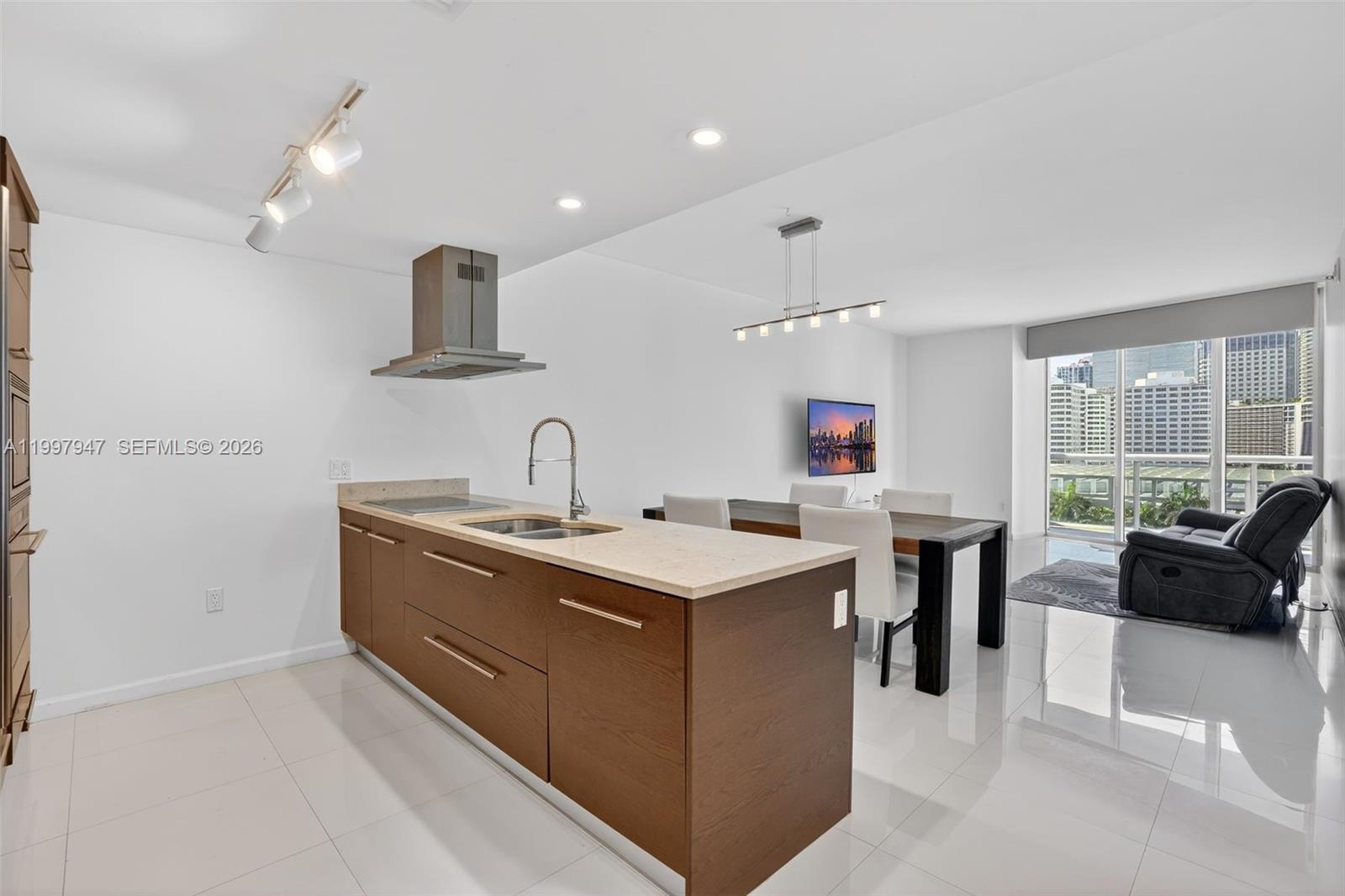 495 Brickell Avenue, Unit 1007 Miami, FL 33131 - Photo 2 of 17 a kitchen with a sink a stove and a refrigerator