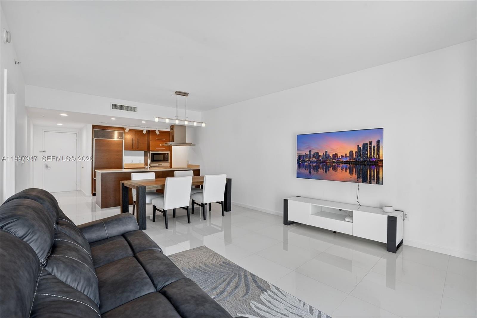 495 Brickell Avenue, Unit 1007 Miami, FL 33131 - Photo 3 of 17 a living room with furniture kitchen view and a window