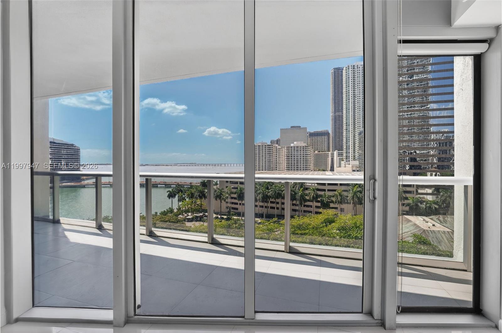 495 Brickell Avenue, Unit 1007 Miami, FL 33131 - Photo 9 of 17 a view of a room with a large window and wooden floor