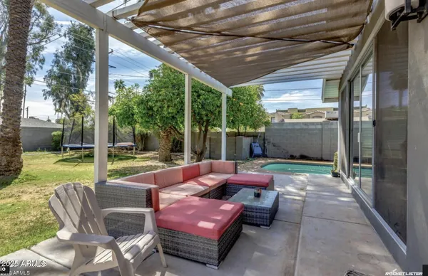 a outdoor space with patio the couches and a dining table and chairs with garden view