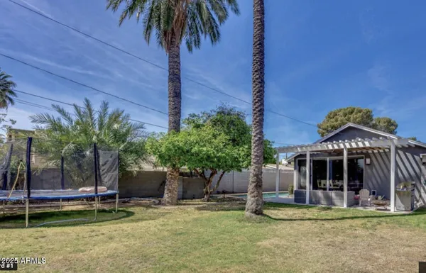 a view of a house with backyard and sitting area