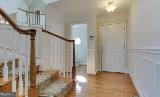 a view of an entryway with wooden floor
