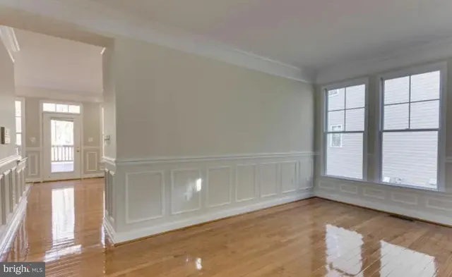 an empty room with windows and entrance