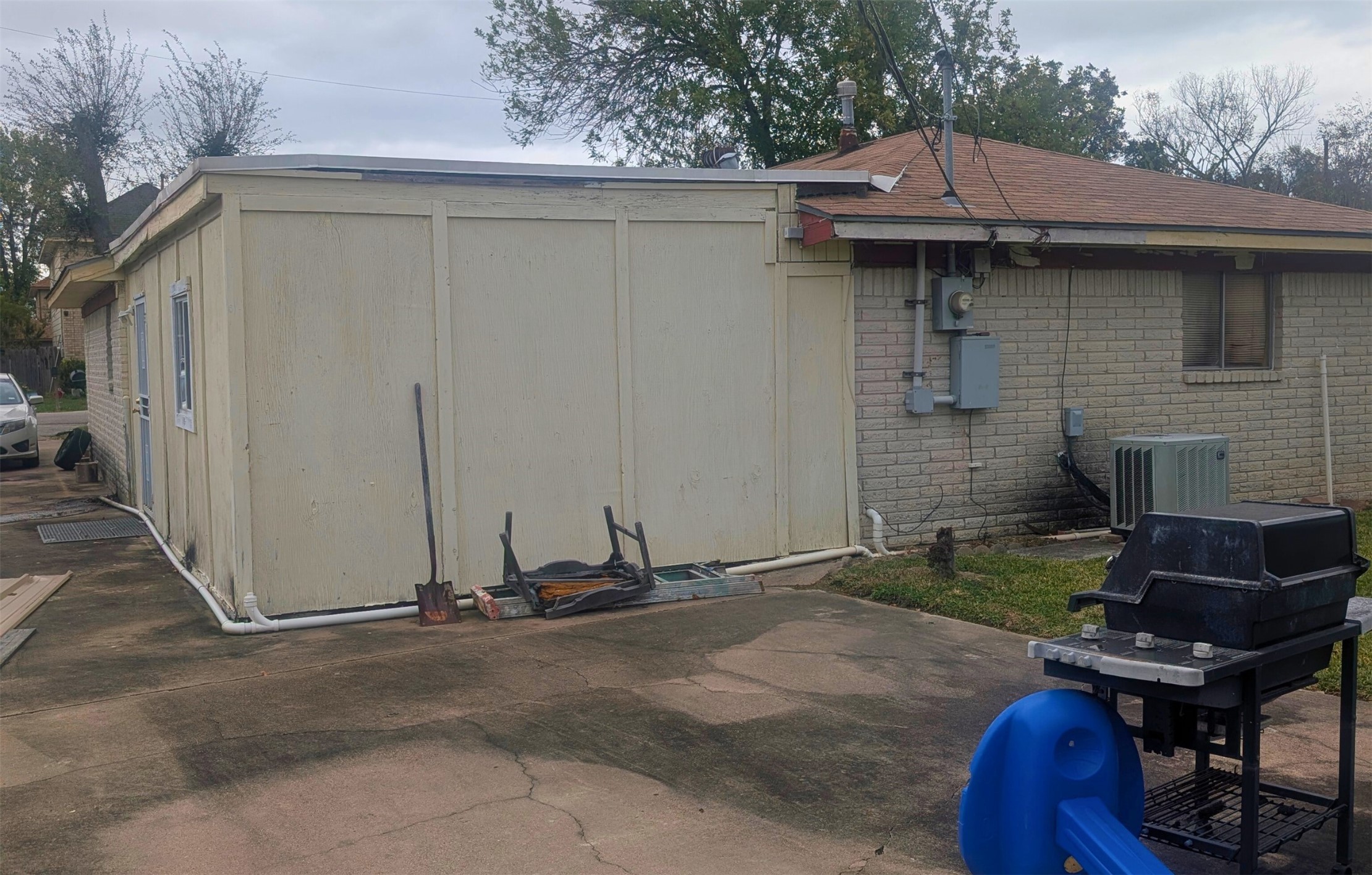 8834 Judwin Street Houston, TX 77075 - Photo 5 of 6 a view of a backyard with chairs and a grill