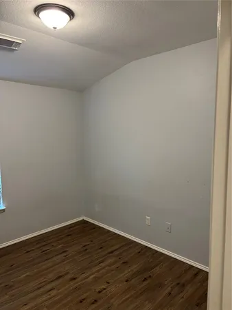 a view of a room with wooden floor