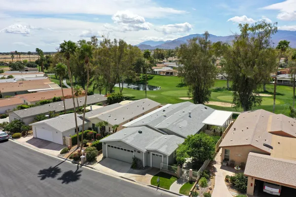 an aerial view of a house with garden space and street view