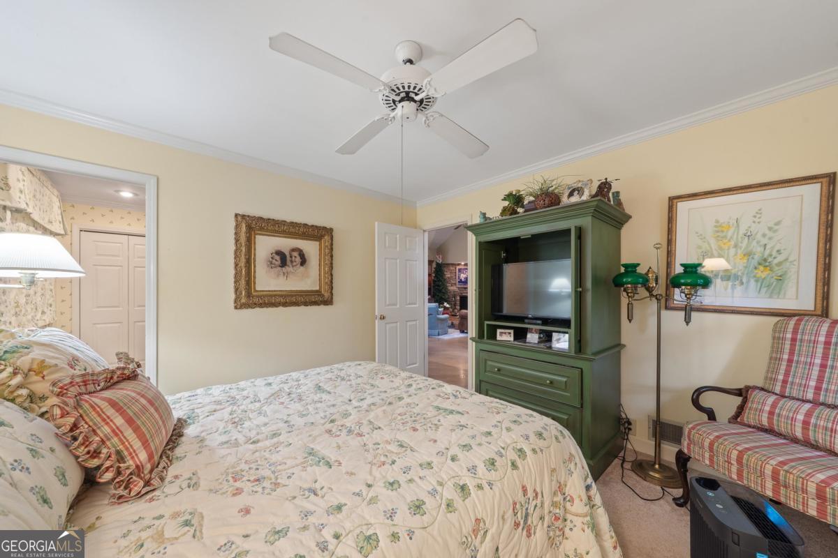 1031 Old Still Road Greensboro, GA 30642 - Photo 39 of 73 a bedroom with a bed and a flat screen tv
