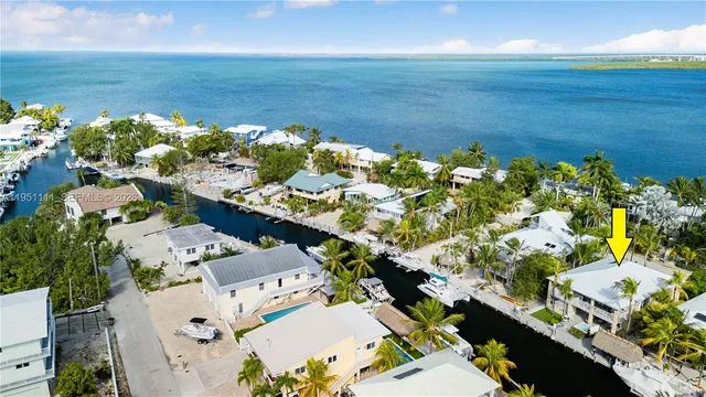 an aerial view of a house with a ocean view