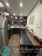 a kitchen with kitchen island a sink stainless steel appliances and cabinets