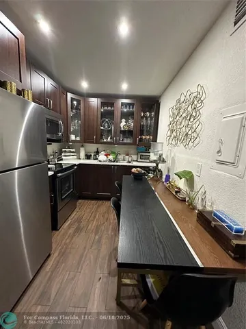 a kitchen with a sink appliances and cabinets