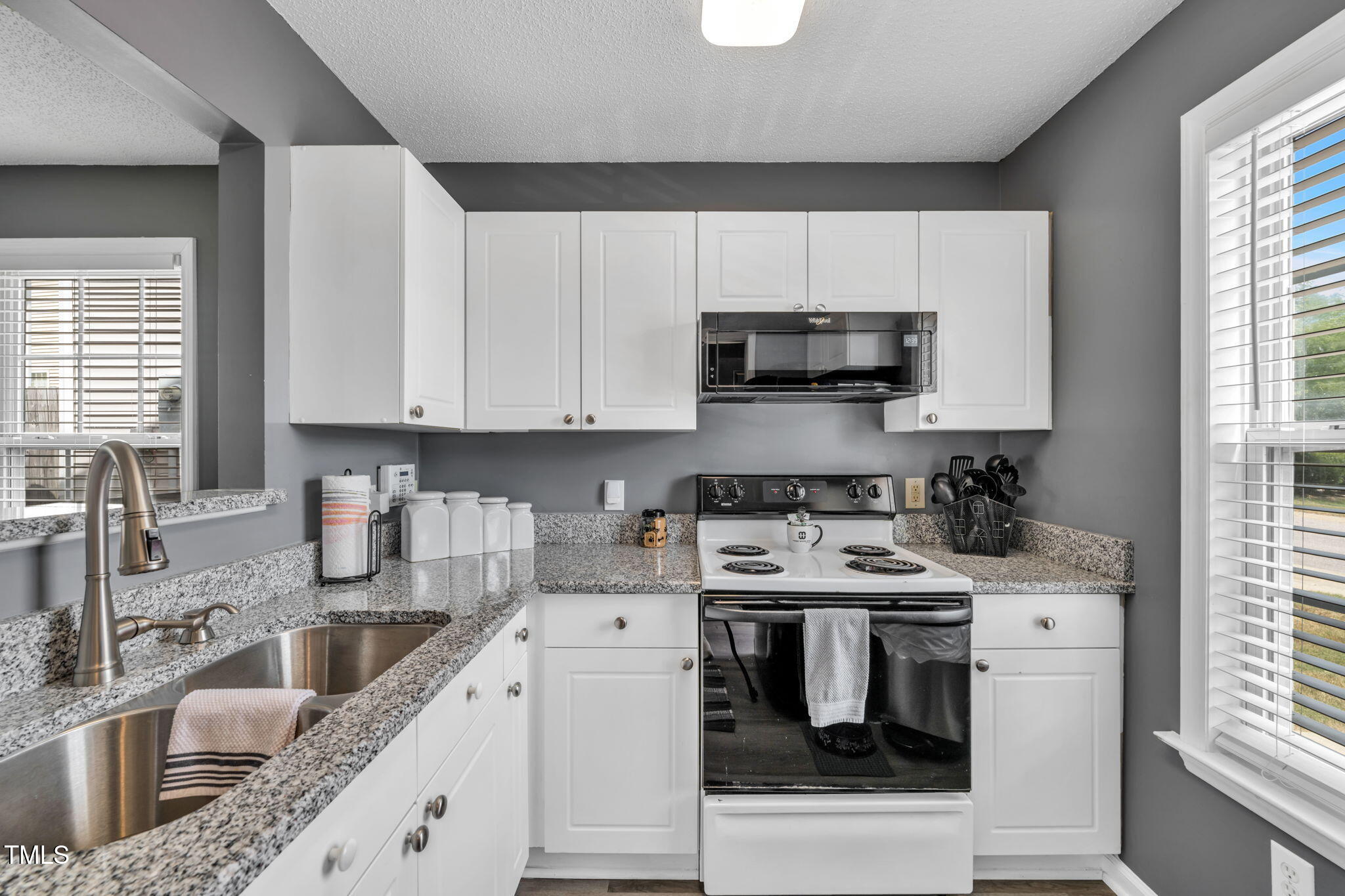 2203 Whistling Straits Way Raleigh, NC 27604 - Photo 8 of 31 a kitchen with stainless steel appliances a stove a sink a stove and a microwave