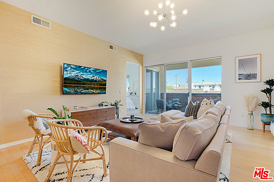 12411 Pacific Avenue, Unit 205 Los Angeles, CA 90066 - Photo 11 of 21 a living room with furniture and a flat screen tv