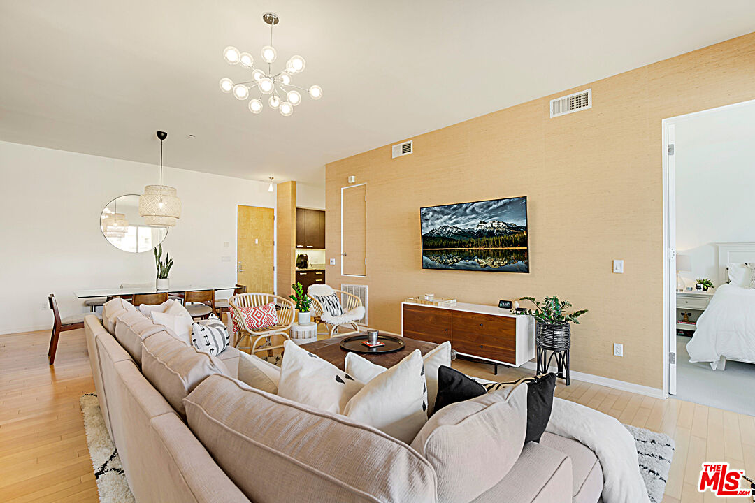 12411 Pacific Avenue, Unit 205 Los Angeles, CA 90066 - Photo 13 of 21 a living room with furniture a chandelier and a flat screen tv