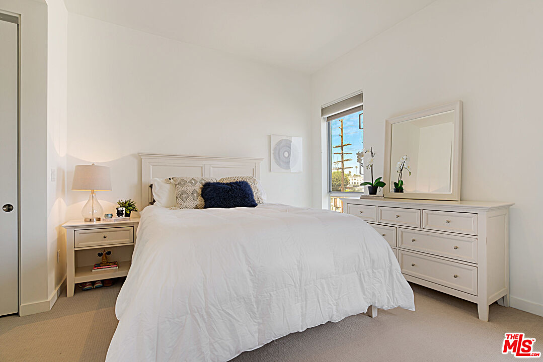 12411 Pacific Avenue, Unit 205 Los Angeles, CA 90066 - Photo 14 of 21 a bedroom with a bed and a dresser