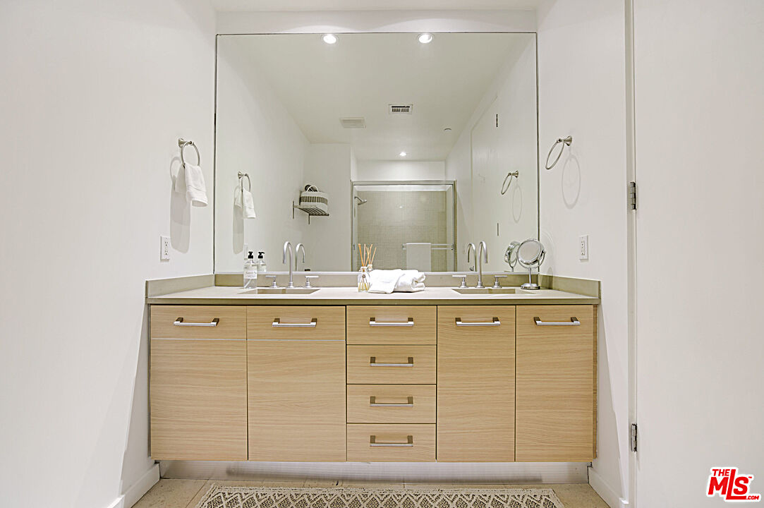 12411 Pacific Avenue, Unit 205 Los Angeles, CA 90066 - Photo 15 of 21 a bathroom with a granite countertop sink mirror and