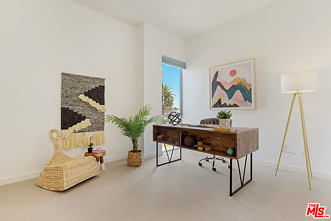 12411 Pacific Avenue, Unit 205 Los Angeles, CA 90066 - Photo 17 of 21 a living room with furniture and a rug