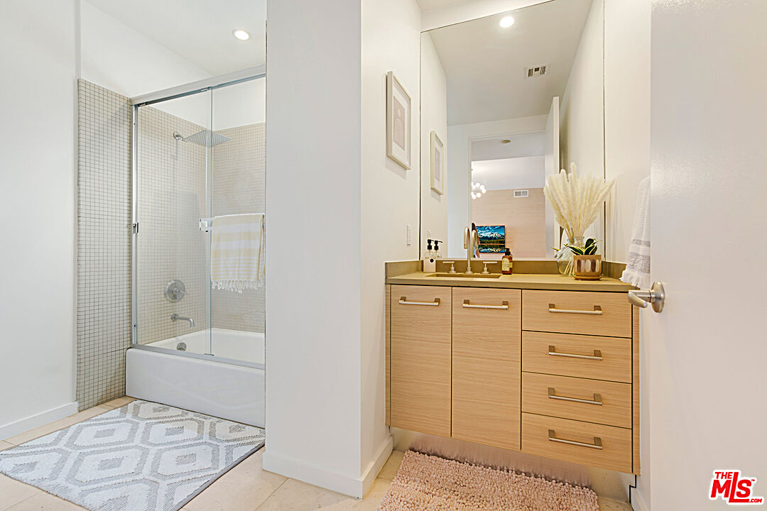 12411 Pacific Avenue, Unit 205 Los Angeles, CA 90066 - Photo 19 of 21 a bathroom with a shower a sink and a mirror