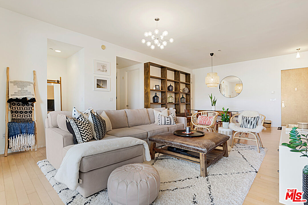 12411 Pacific Avenue, Unit 205 Los Angeles, CA 90066 - Photo 3 of 21 a living room with furniture and a chandelier