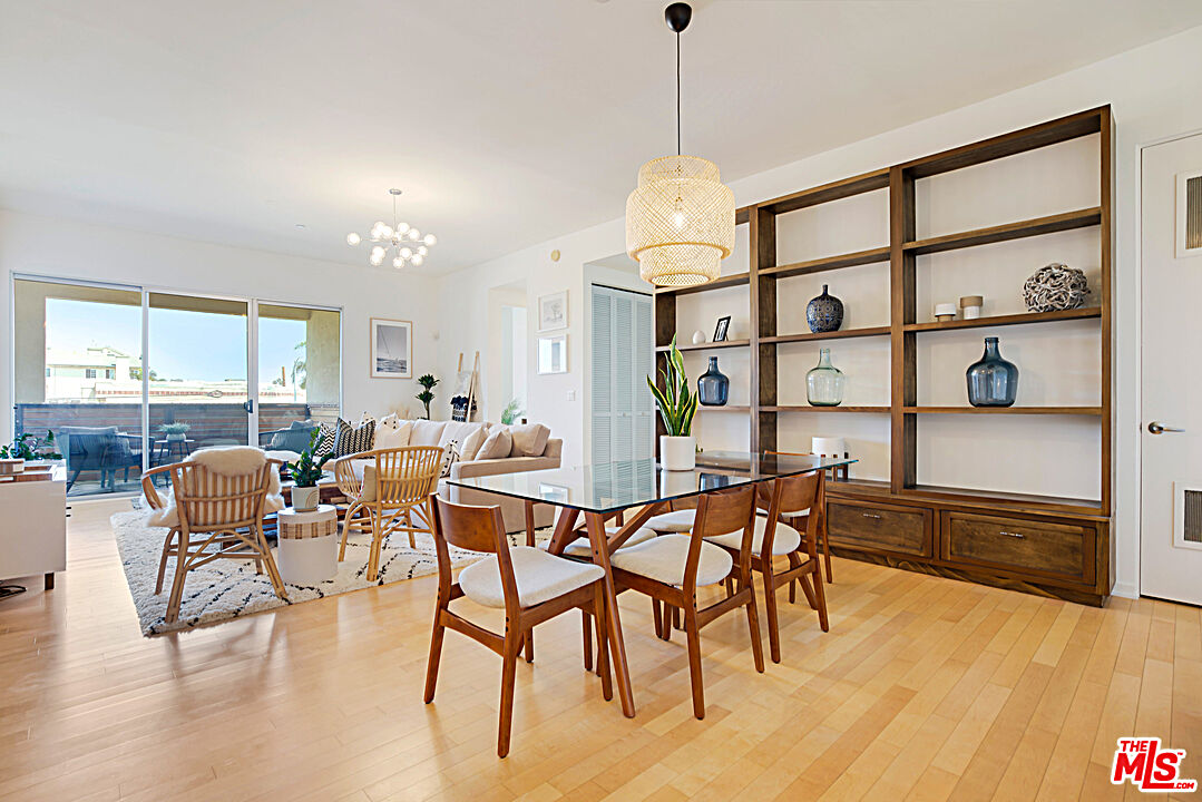 12411 Pacific Avenue, Unit 205 Los Angeles, CA 90066 - Photo 10 of 21 a view of a dining room with furniture window and wooden floor