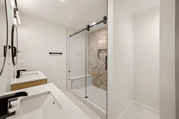 a bathroom with a shower and a sink