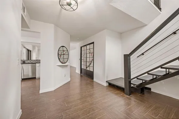 a view of an entryway with wooden floor