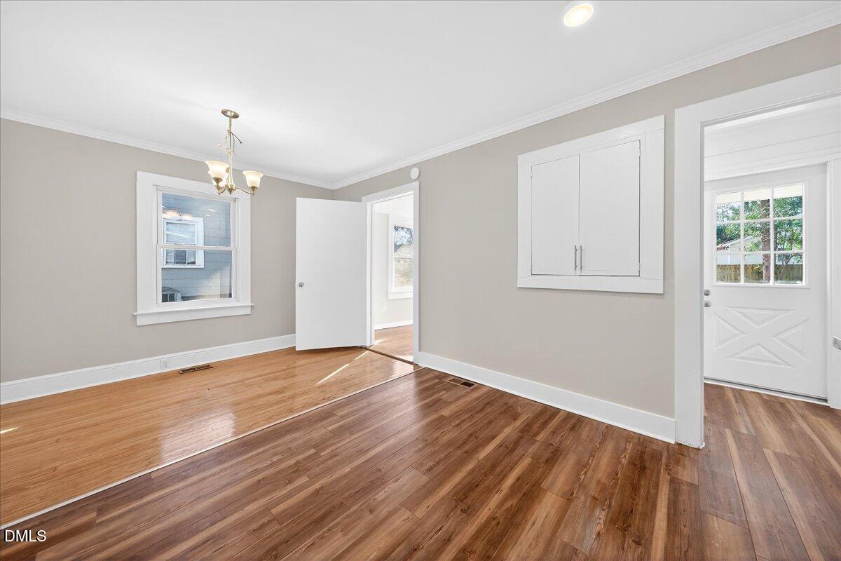 23 West Academy Street Wendell, NC 27591 - Photo 13 of 31 a view of an empty room with wooden floor and a window