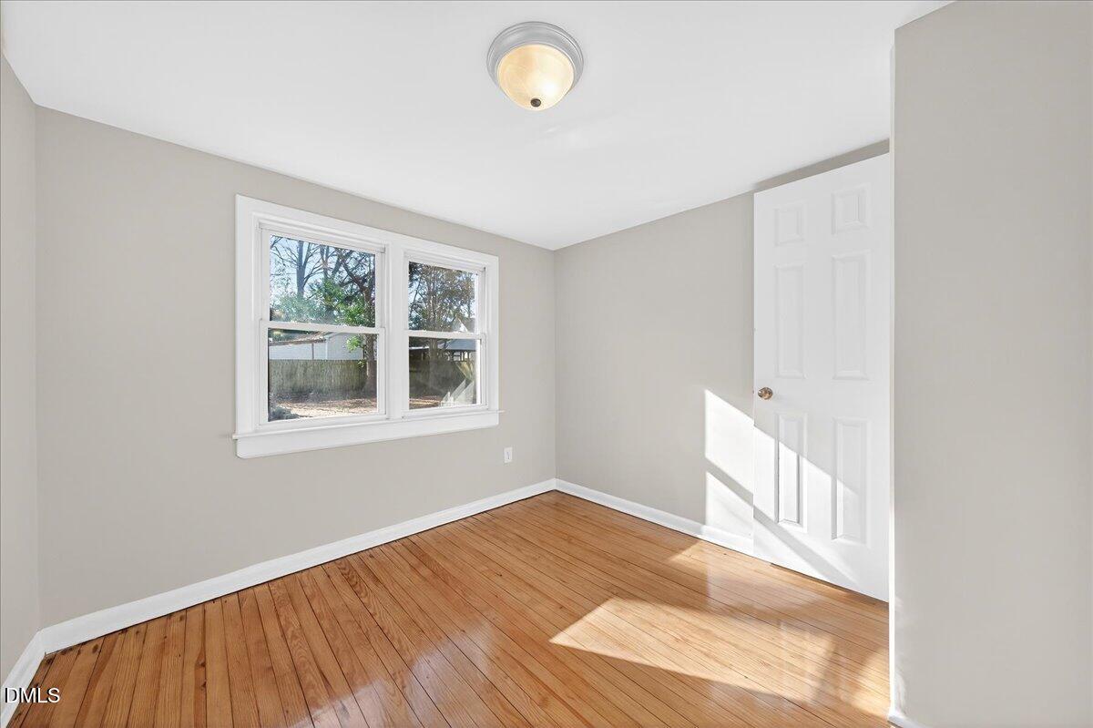 23 West Academy Street Wendell, NC 27591 - Photo 14 of 31 a view of an empty room with window and wooden floor
