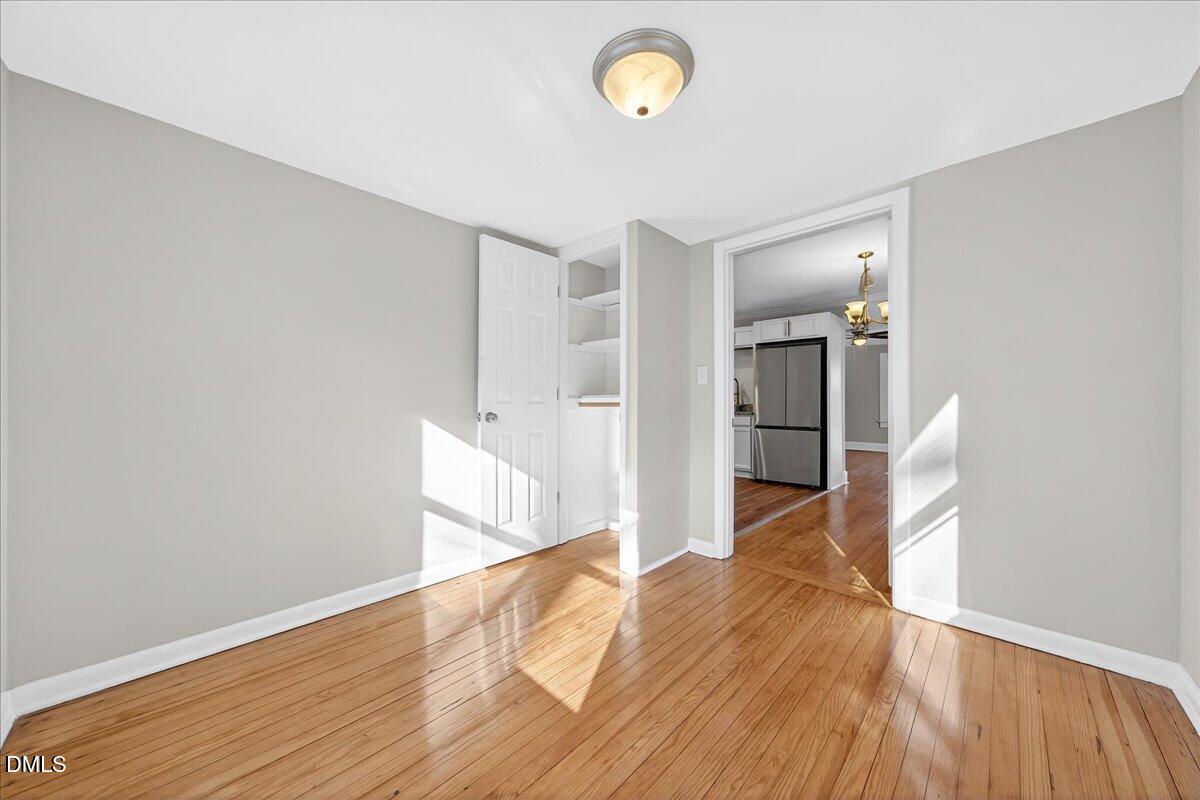 23 West Academy Street Wendell, NC 27591 - Photo 15 of 31 a view of empty room with wooden floor