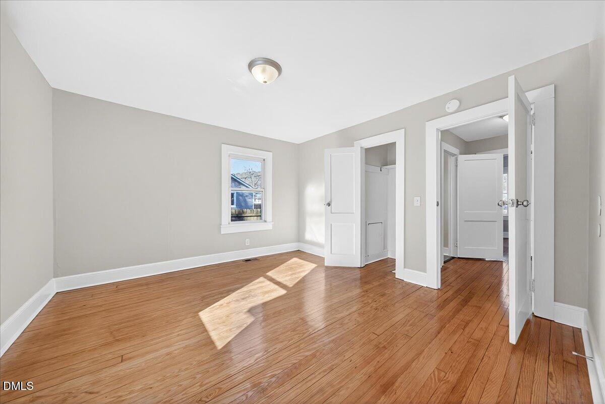 23 West Academy Street Wendell, NC 27591 - Photo 16 of 31 a view of empty room with wooden floor