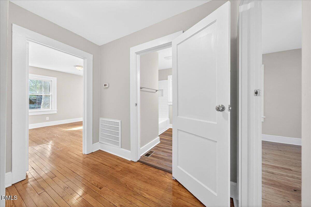 23 West Academy Street Wendell, NC 27591 - Photo 19 of 31 a view of a hallway with wooden floor and closet