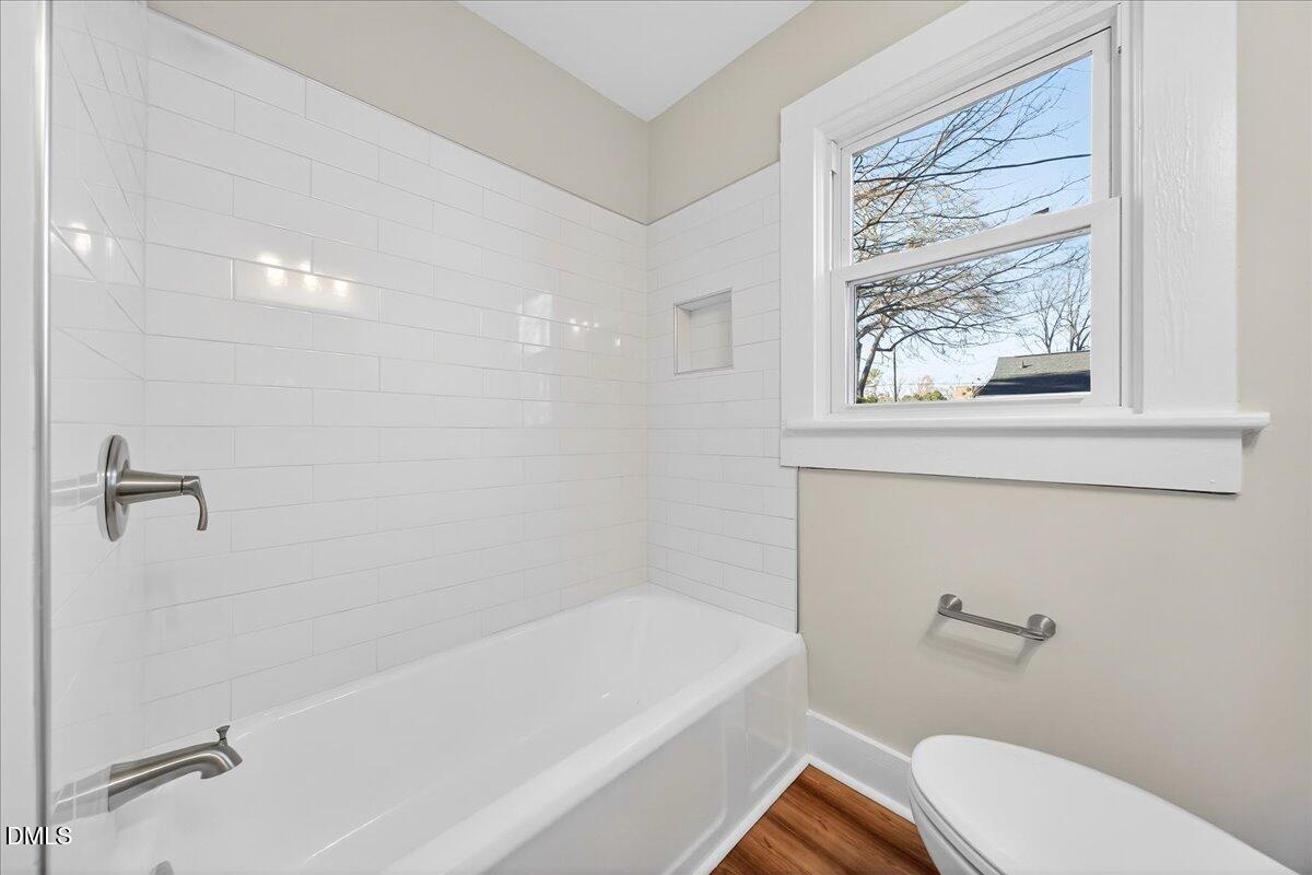 23 West Academy Street Wendell, NC 27591 - Photo 20 of 31 a bathroom with a toilet and a bath tub