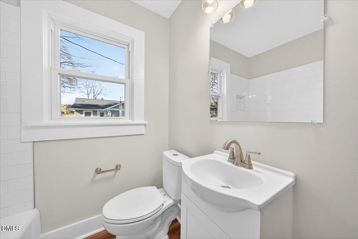 23 West Academy Street Wendell, NC 27591 - Photo 21 of 31 a bathroom with a toilet a sink and mirror