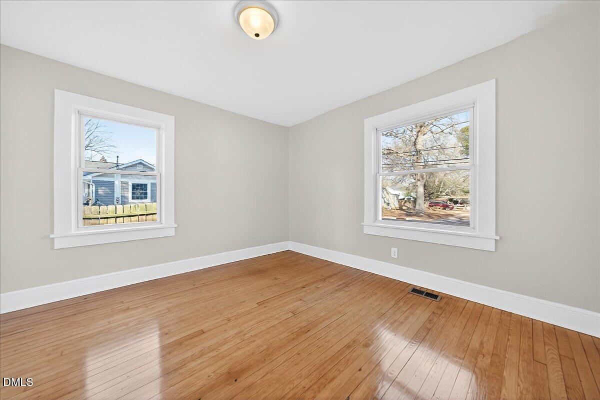 23 West Academy Street Wendell, NC 27591 - Photo 22 of 31 a view of an empty room with window and wooden floor