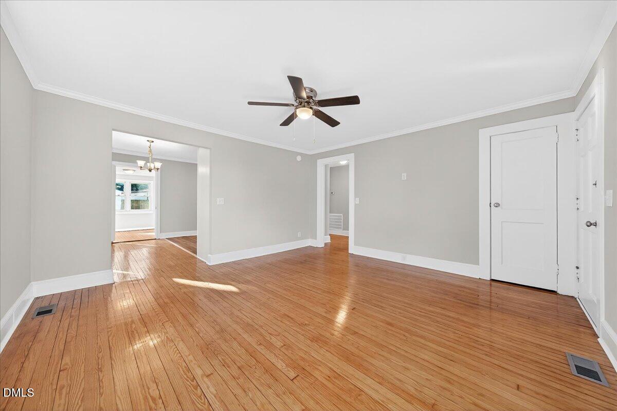 23 West Academy Street Wendell, NC 27591 - Photo 4 of 31 a view of empty room with wooden floor and ceiling fan