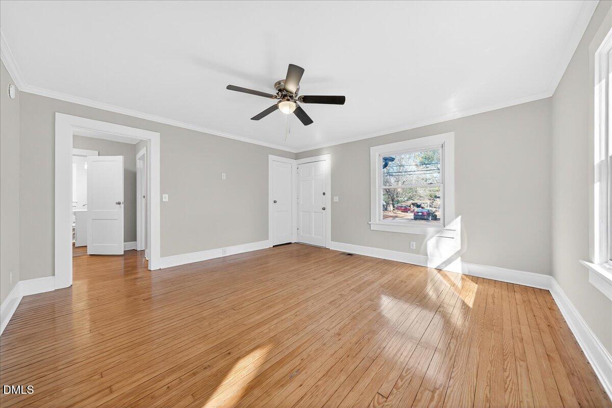 23 West Academy Street Wendell, NC 27591 - Photo 6 of 31 a view of a livingroom with wooden floor and a ceiling fan