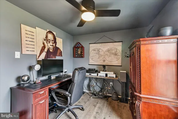 a view of a workspace with furniture and a window