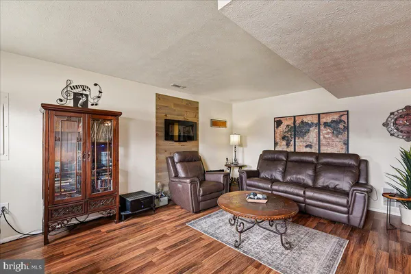 a living room with furniture a rug and a window