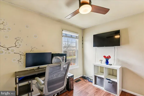 a work room with furniture and a flat screen tv