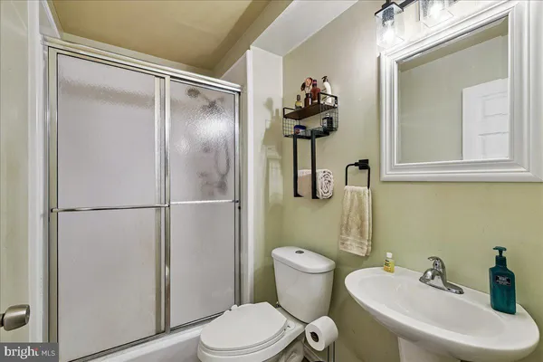 a white toilet sitting next to a bathroom sink