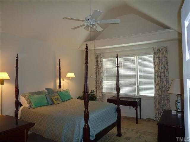 2908 Hawtree Drive Raleigh, NC 27613 - Photo 4 of 12 a bedroom with a bed table and chair