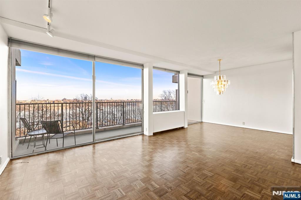 3 Horizon Road, Unit G11 Fort Lee, NJ 07024 - Photo 5 of 25 an empty room with sliding door and windows